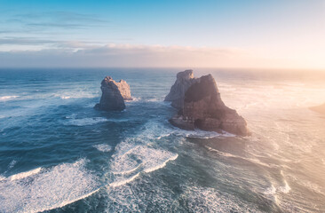 Wall Mural - Sunrise shining over Wharariki beach and archway islands on Tasman sea at Cape Farewell, New Zealand