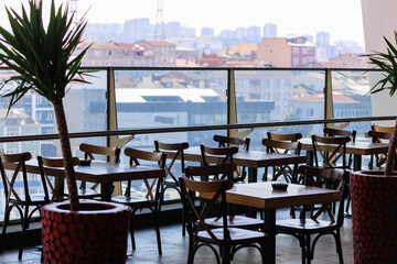 Wall Mural - Beautiful views from above, tables in a cafe in the mountains and a panoramic view of the city, public places in Turkey, on a sunny summer day