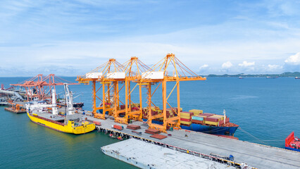 Crane loading box container to cargo ship at commercial dock port. Shipyard Cargo Container Sea Port Freight forwarding service logistics and transportation. International Shipping  Customs Port..