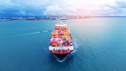 Wall Mural - Front view of  Cargo container ship carrying container and running out international container port customs shipyard sea port concept smart logistic service.