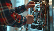 © Oleksiy - Man repairing gas boiler with screwdriver indoors, closeup