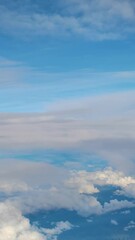 Wall Mural - Blue Sky and White Clouds seen from airplane in Thailand - On the way from Nan to Bangkok - Blue Nature Footage 