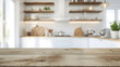 © Iryna - Empty wooden tabletop on blurred white kitchen background for mockups. Natural day light. Promotion background.