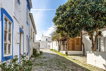 Wall Mural - The fishing village Cacela Velha in southern Portugal. White facades of houses with colored decorations.