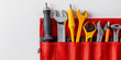 © Armin - A selection of various hand tools organized neatly in a red tool holder, perfect for DIY projects or professional work, laying on a white background.