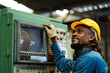 © KANGWANS - Black male mechanical engineer working at metal lathe factory Machine lathe operating engineer African American people.