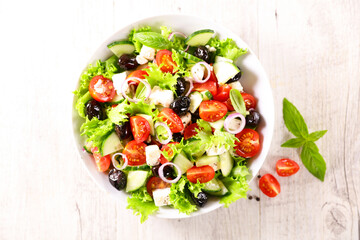 Wall Mural - mixed vegetable salad with lettuce, tomatoes, cucumber and olives