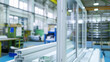 © AndreyFrol - An assembled window frame with double-glazed windows standing on a table next to plastic profiles in a bright assembly workshop. Copy space