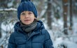 © imagineRbc - A young boy wearing a blue jacket and hat walking outdoors