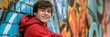 © gunzexx png and bg - Young teenager with curly hair smiling in front of a vibrant graffiti wall background