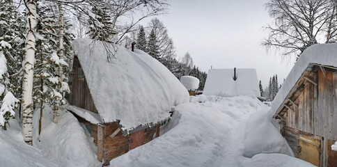 Canvas Print - Russia. Kuznetsk Alatau. Winter view of the holiday village of Borisovka among the snow-covered impassable taiga on the banks of the Tom River.