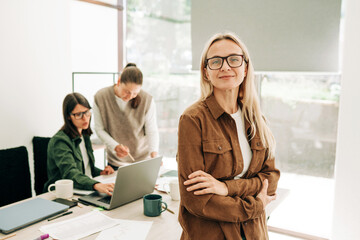 Portrait of a modern attractive blonde cosmopolitan business woman in the office.