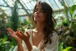 © Yuliia - Close-up photo of female Hispanic healer transmitting energy with hands at botanical garden.
