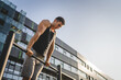 © Miljan Živković - One man muscular male athlete training pull ups outdoor in sunny day