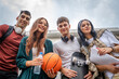 © Miljan Živković - group of teenage students gen z sit in front of school university