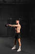 © Halfpoint - Man performing kettlebell swings, holding kettlebell in both hands. Routine workout for physical and mental health.