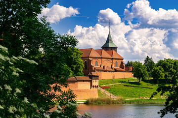 Wall Mural - Ancient medieval village church reflected in the river water	