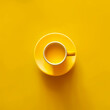 © RooM The Agency - Overhead view of a yellow cup filled with a hot drink on a yellow background