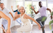 © JackF - Group of multiethnic mature active people dancing hip hop dance movements in studio..