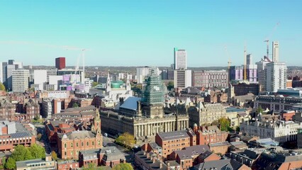 Canvas Print - Aerial footage of the Leeds City Centre showing construction work being done on the famous Leeds Town Hall, taken on a bright sunny day with the drone flying through the city centre on a bright day