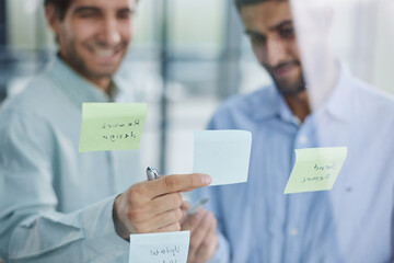 Wall Mural - two successful businessmen in the office discuss a plan on stickers