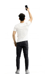 Wall Mural - A man, on a white background, in full height, waving his phone