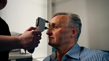 Wall Mural - in an ophthalmology clinic checking the pressure of the eyeball of an elderly patient