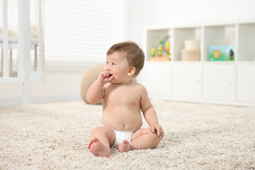 Canvas Print - Cute baby boy sitting on carpet at home