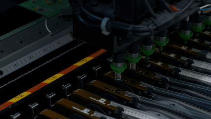 Poster - Close up of details of automatic SMD pick and place machine during work. Creative. Assembly of computer printed circuit board at factory.