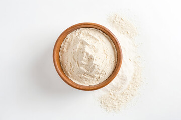 Wall Mural - Top View of a Wooden Bowl Filled with Flour on a White Surface