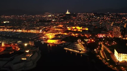 Wall Mural - Panoramic night view of the old port and Notre Dame de la Garde Cathedral, city of Marseille in South France
