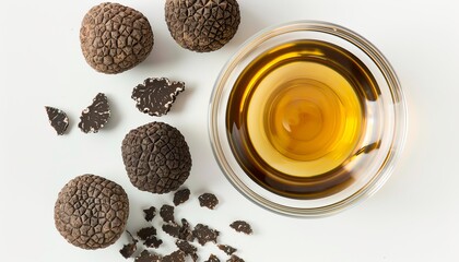 Wall Mural - Top view of a white background with a glass bowl holding oil and fresh truffles
