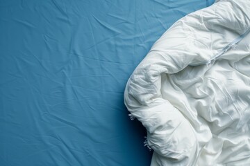 Wall Mural - Top view of modern white bed on blue fabric with white blanket isolated on white background