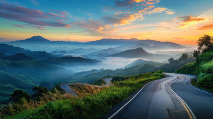 Asphalt highway road winds through majestic mountain scenery at sunrise, offering a panoramic view of nature's grandeur.