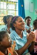 © tantawat - A candid shot of a teacher and students engaged in a classroom activity, highlighting the joy of learning
