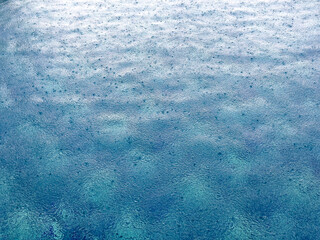 Poster - Raindrops on blue pool water. Background