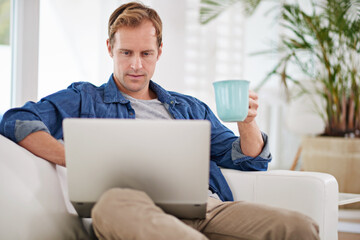 Canvas Print - Home, coffee and man with laptop on sofa for remote work, communication and reading job website. Living room, person and technology with internet in morning for freelance email, planning and review