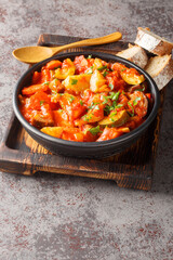 Guvech or Ghivechi Bulgarian and Romanian rustic vegetable stew Closeup on the bowl on the table. Vertical