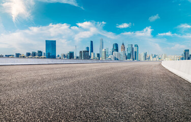 Wall Mural - Empty asphalt road and modern city skyline background