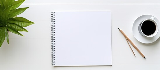 Fototapete - Top view of a white office desk table with essential work items like a laptop pen smartphone rope and notebook The image offers an ample copy space for customization