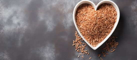 Aufkleber - Brown rice in heart shaped bowl on gray cement background Copy space Top view or flat lay