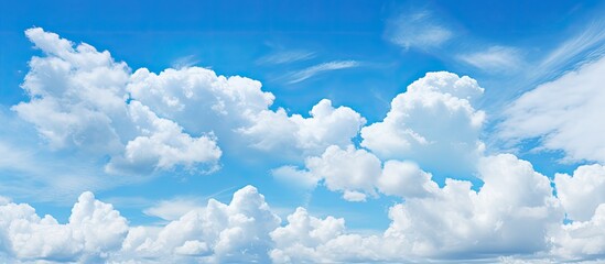 Poster - A stunning 21 9 view of a blue sky background featuring fluffy clouds with ample copy space image
