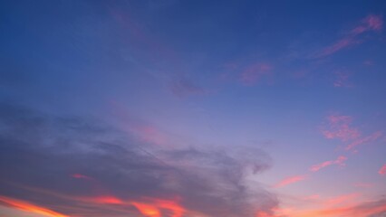 Wall Mural - a vivid sunset with a sky that transitions from deep blue at the top to soft pink and orange near th