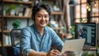 © K-MookPan - Photo of Asian businessman talking to colleague team in video call conference writing note on book with smile face