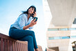 © Westend61 - Contemplative businesswoman holding smart phone sitting on bench