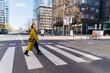 © Westend61 - Fashionable businesswoman crossing street in city