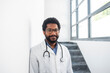 © Westend61 - Smiling doctor wearing eyeglasses standing in hospital staircase