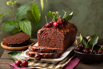 Poster - Chocolate Cherry Loaf Cake with ganache cream and fresh cherries.  Homemade summer bakery. Green background.