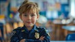 © nicole - Little boy dressed as a police officer, looking confidently at the camera against a blurred school classroom background. space for copy, ideal for educational themes or children's career aspirations
