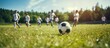 © Ilgun - School children practicing football on a grass field during a summer training camp with a group of kids running and kicking soccer balls in an image with copy space